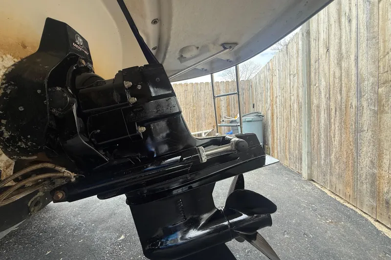 Slide: The Image of 2009 Monterey 214FS boat engine and propeller in a driveway setting. - 21