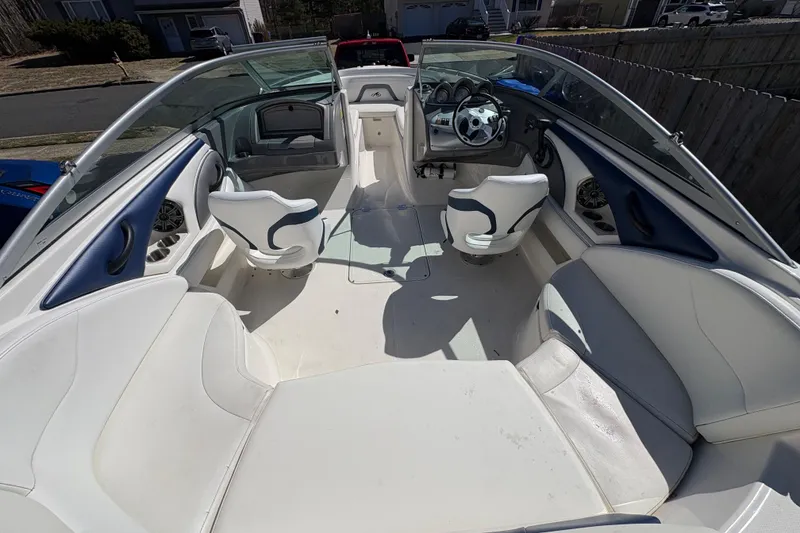 Slide: The Image of 2009 Monterey 214FS boat interior with white seating and steering wheel. - 6