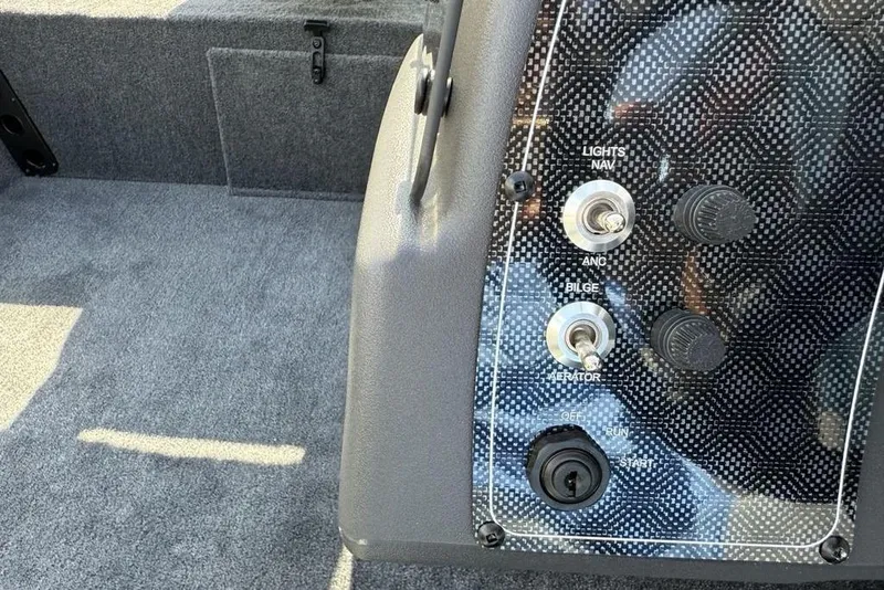 Slide: The Image of Control panel of 2026 Tracker Bass Tracker Classic XL boat with switches and dials. - 13