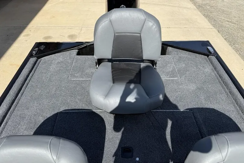 Slide: The Image of 2026 Tracker Bass Tracker Classic XL boat interior with gray seating and carpeted deck. - 14