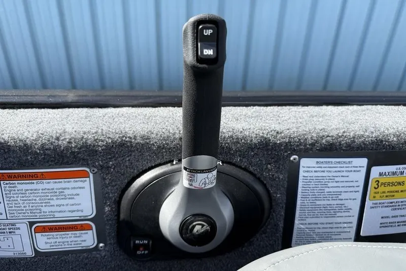 Slide: The Image of Throttle control lever on a 2026 Tracker Bass Tracker Classic XL boat dashboard. - 16
