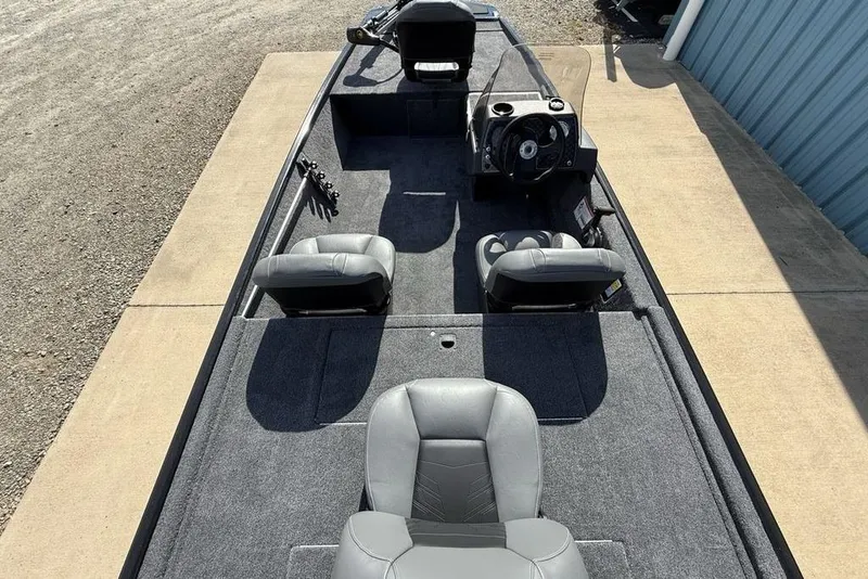 Slide: The Image of 2026 Tracker Bass Tracker Classic XL boat interior with seating and steering console. - 18