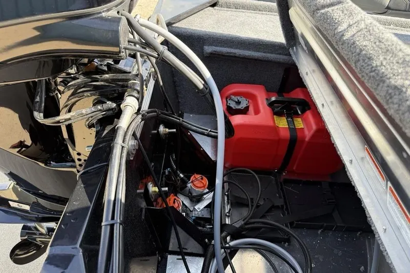 Slide: The Image of 2026 Tracker Bass Tracker Classic XL boat engine compartment with red fuel tank and wiring. - 20