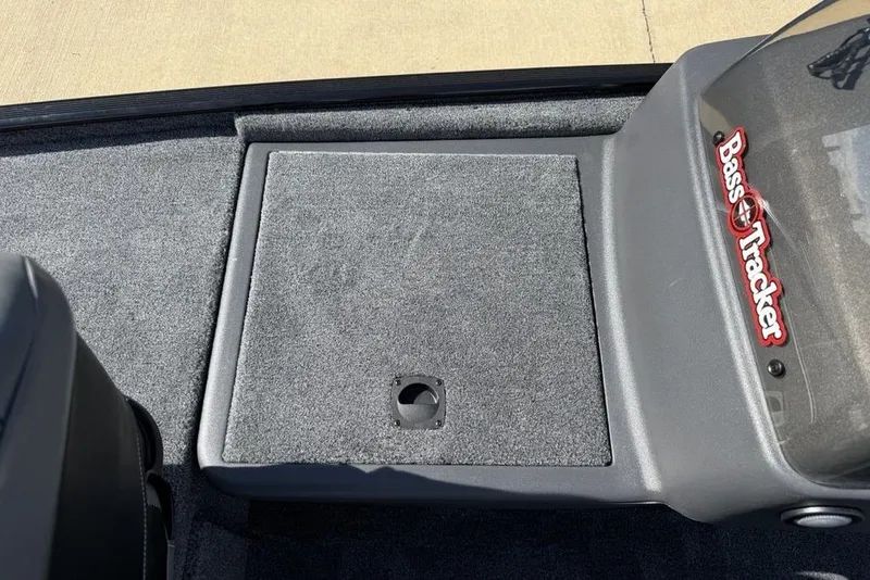 Slide: The Image of 2026 Tracker Bass Tracker Classic XL boat interior with carpeted deck and logo. - 4