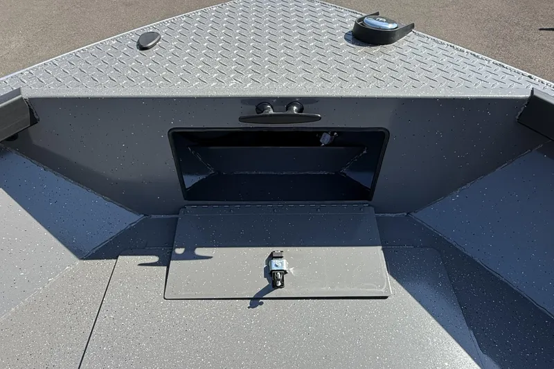 Slide: The Image of 2025 Alumaweld Free Drifter 20 boat interior with storage compartment and diamond plate flooring. - 21