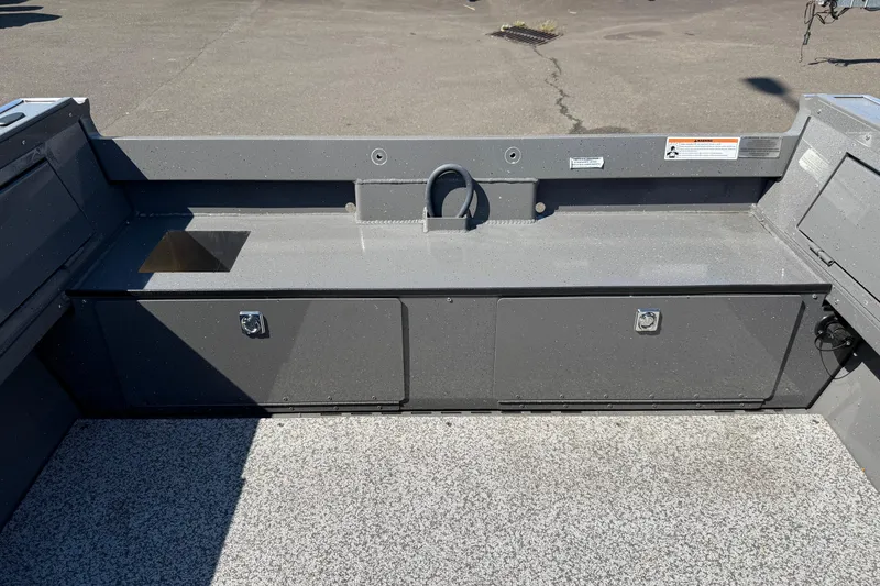 Slide: The Image of 2025 Alumaweld Free Drifter 20 boat interior with storage compartments and utility sink. - 35