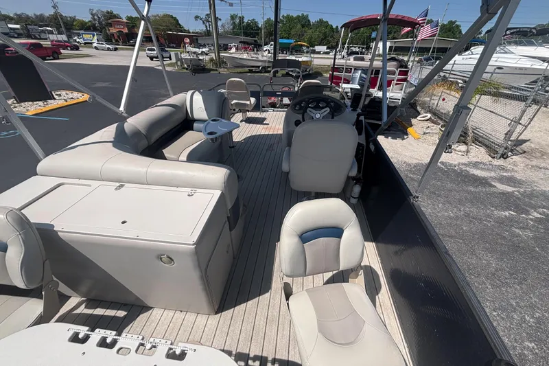 Slide: The Image of 2015 Manitou 20 Oasis Angler pontoon boat interior with seating and steering console. - 10