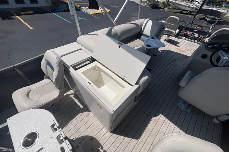 Slide: The Image of 2015 Manitou 20 Oasis Angler boat interior with open storage compartment. - 11