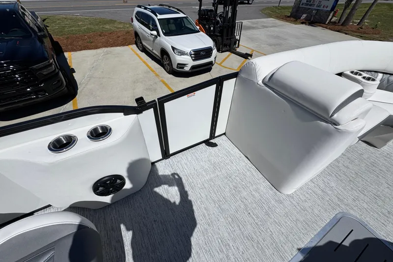Slide: The Image of 2026 Bennington 22 LXS Swingback boat interior with seating and cup holders. - 22