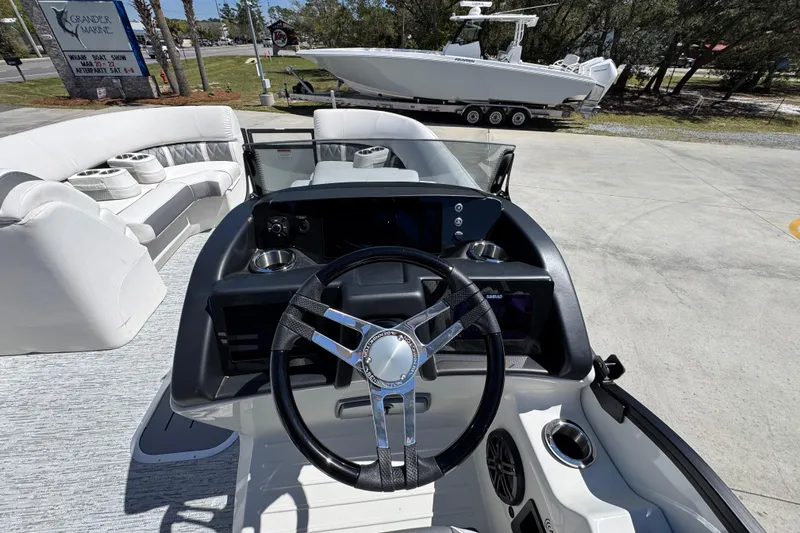 Slide: The Image of 2026 Bennington 22 LXS Swingback boat interior with steering wheel and seating area. - 24