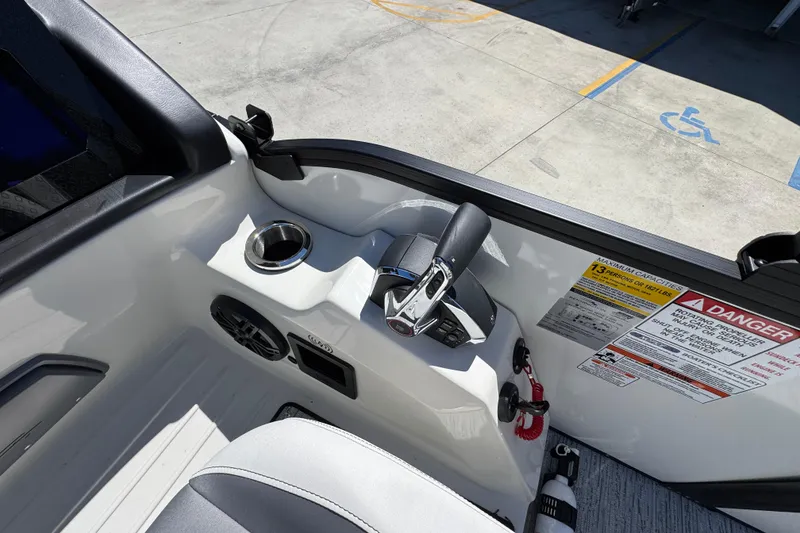 Slide: The Image of Interior of 2026 Bennington 22 LXS Swingback boat with control panel and safety warnings. - 25