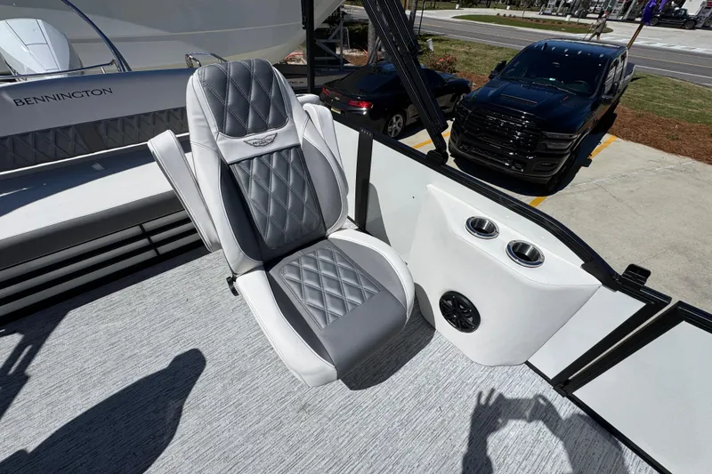 Slide: The Image of 2026 Bennington 22 LXS Swingback boat interior with luxury seating and cup holders. - 27