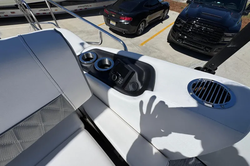Slide: The Image of Interior of 2026 Bennington 22 LXS Swingback boat with cup holders and control panel. - 30