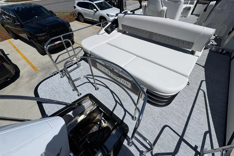 Slide: The Image of 2026 Bennington 22 LXS Swingback boat with white seating and sleek design in parking lot. - 33