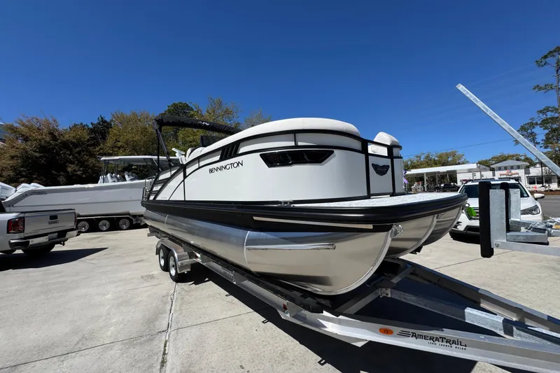 Slide: The Image of 2026 Bennington 22 LXS Swingback pontoon boat on trailer, outdoor setting. - 6
