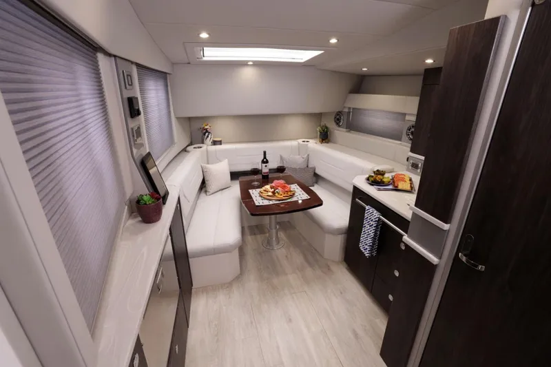 Slide: The Image of Manufacturer Provided Image: 2023 Formula 430 Super Sport Crossover interior with dining area and kitchenette. - 12