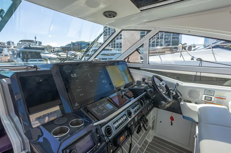 Slide: The Image of 2023 Formula 430 Super Sport Crossover cockpit with advanced navigation displays and controls. - 16