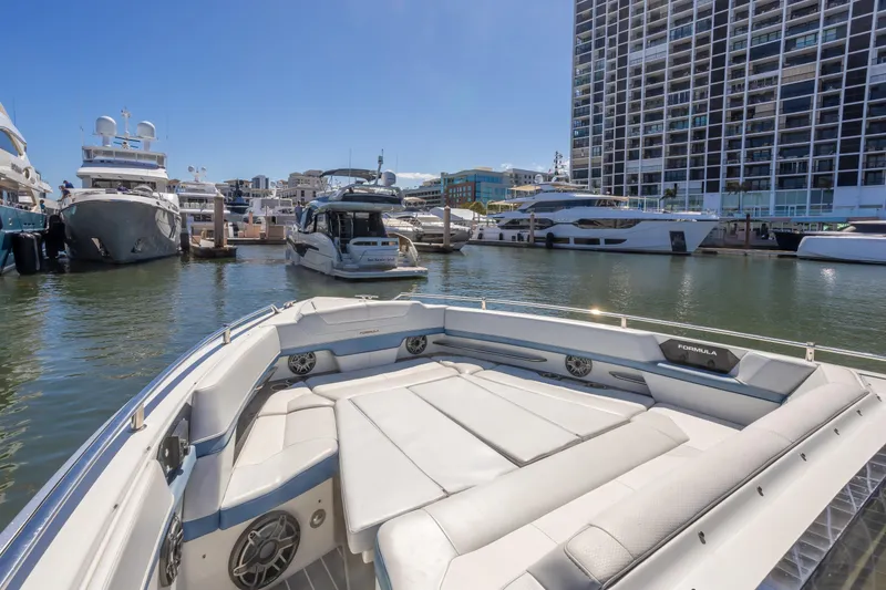 Slide: The Image of 2023 Formula 430 Super Sport Crossover in marina, surrounded by luxury yachts. - 19