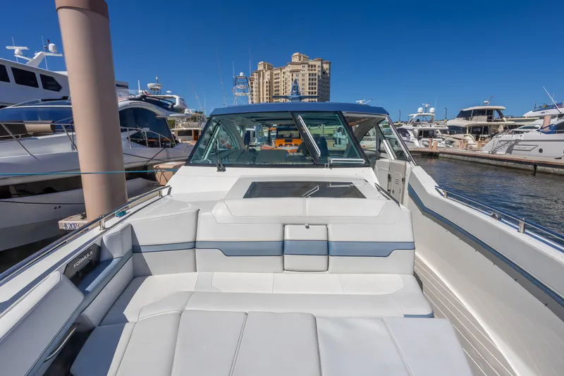 Slide: The Image of 2023 Formula 430 Super Sport Crossover yacht docked at marina, showcasing luxury seating. - 22