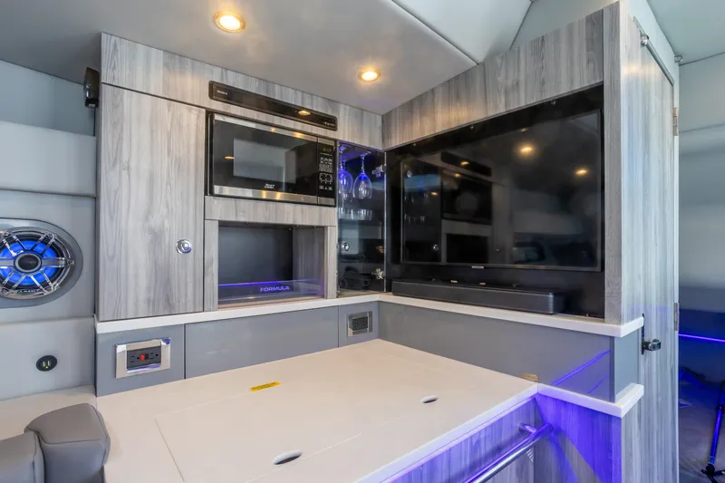 Slide: The Image of 2023 Formula 430 Super Sport Crossover interior with modern kitchen and entertainment setup. - 26