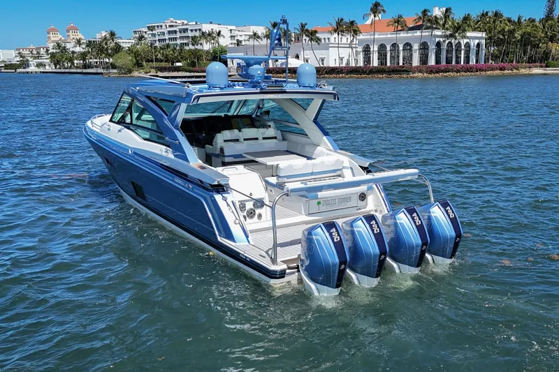 Slide: The Image of 2023 Formula 430 Super Sport Crossover boat on water, featuring four powerful outboard engines. - 6