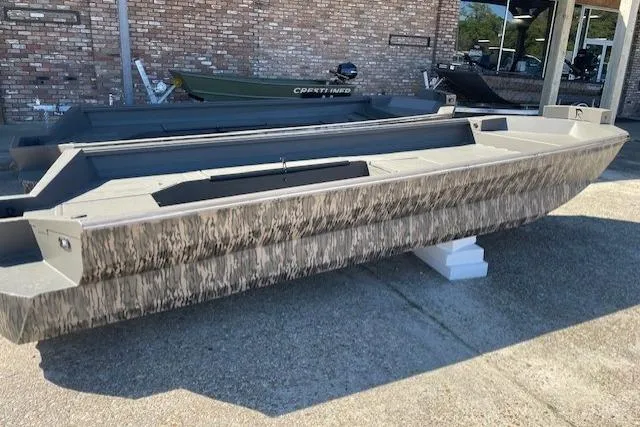 Slide: The Image of 2026 Reaper Boats 756-2004 model displayed outdoors on concrete blocks. - 2