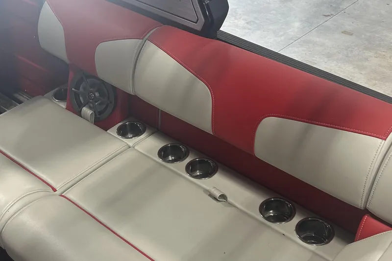 Slide: The Image of 2023 Montara 25 Surf Boss 2.0 CW interior with red and white seating, cup holders, and speaker. - 10