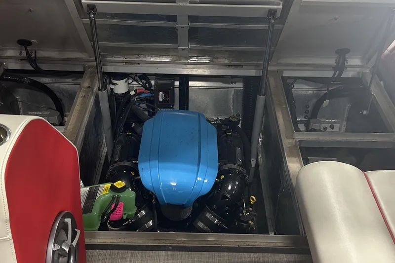 Slide: The Image of Engine compartment of 2023 Montara 25 Surf Boss 2.0 CW boat, featuring a blue engine cover. - 22