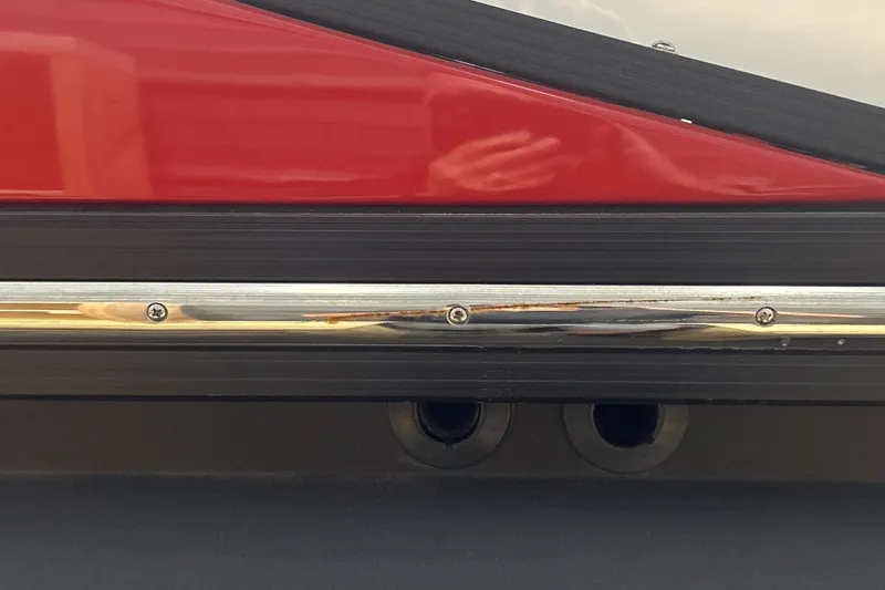 Slide: The Image of Close-up of 2023 Montara 25 Surf Boss 2.0 CW boat detailing with red and black trim. - 23
