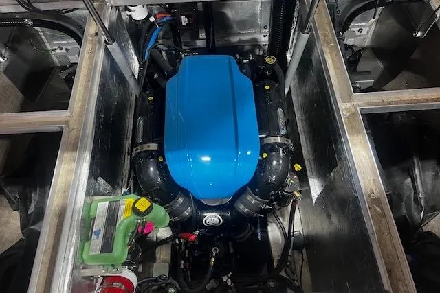 Slide: The Image of 2023 Montara 25 Surf Boss 2.0 CW engine compartment with blue engine cover. - 26