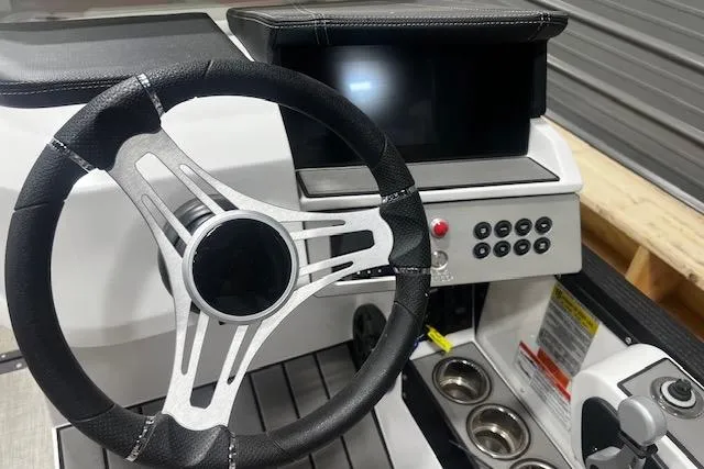 Slide: The Image of 2023 Montara 25 Surf Boss 2.0 CW dashboard with steering wheel and control panel. - 4