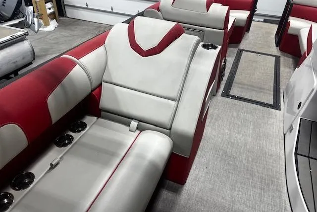 Slide: The Image of 2023 Montara 25 Surf Boss 2.0 CW interior with red and white seating, cup holders. - 9