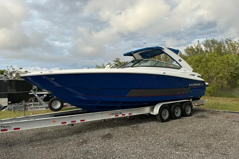 Slide: The Image of 2019 Monterey 328SS Super Sport boat on a trailer, parked outdoors. - 10