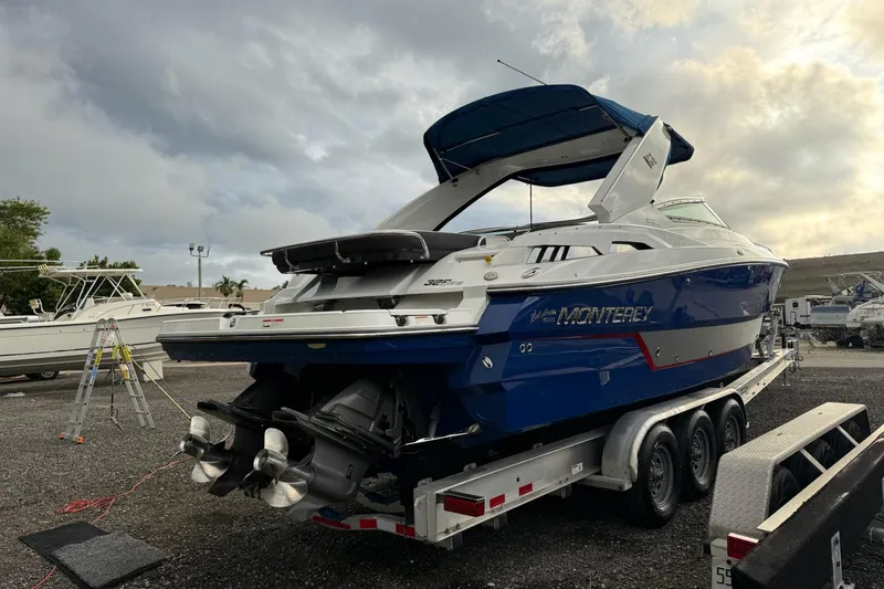 Slide: The Image of 2019 Monterey 328SS Super Sport boat on trailer under cloudy sky. - 12