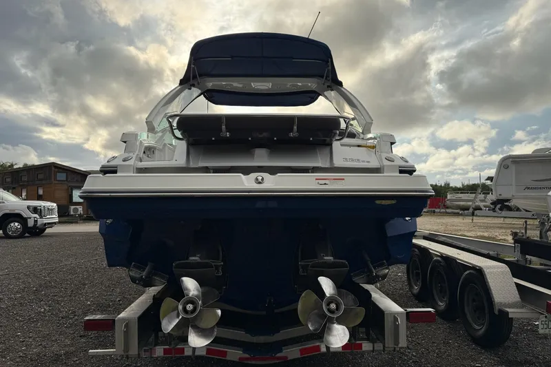 Slide: The Image of 2019 Monterey 328SS Super Sport boat on trailer, rear view under cloudy sky. - 13