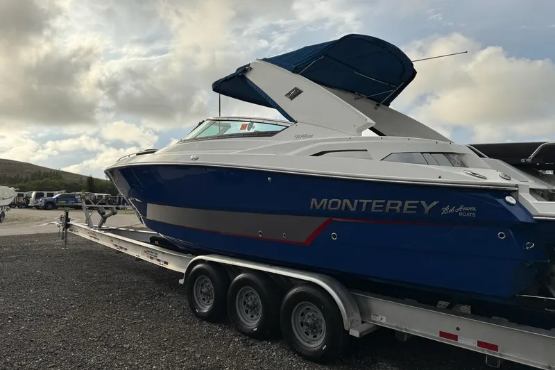 Slide: The Image of 2019 Monterey 328SS Super Sport boat on trailer under cloudy sky. - 16
