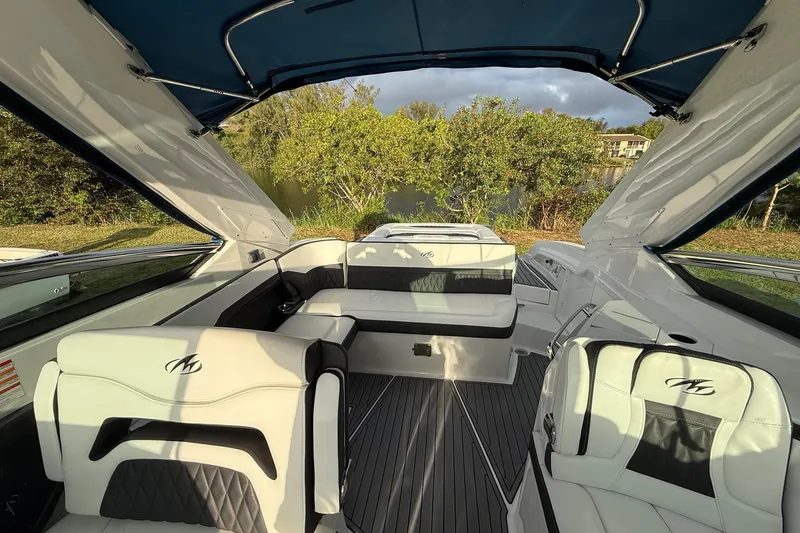 Slide: The Image of 2019 Monterey 328SS Super Sport boat interior with luxurious seating and canopy. - 17