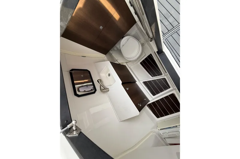 Slide: The Image of 2019 Monterey 328SS Super Sport boat interior with sink, toilet, and storage cabinets. - 25