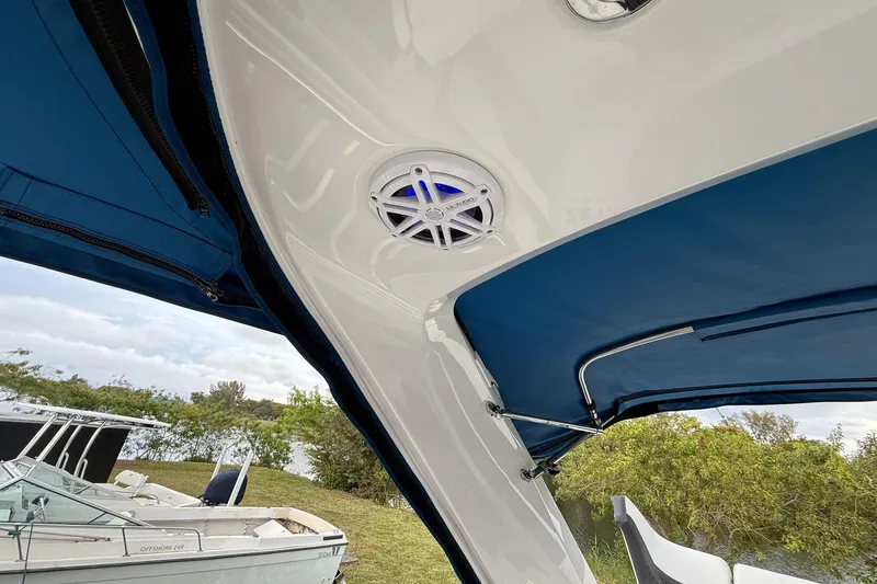 Slide: The Image of 2019 Monterey 328SS Super Sport boat with blue canopy and speaker system. - 29