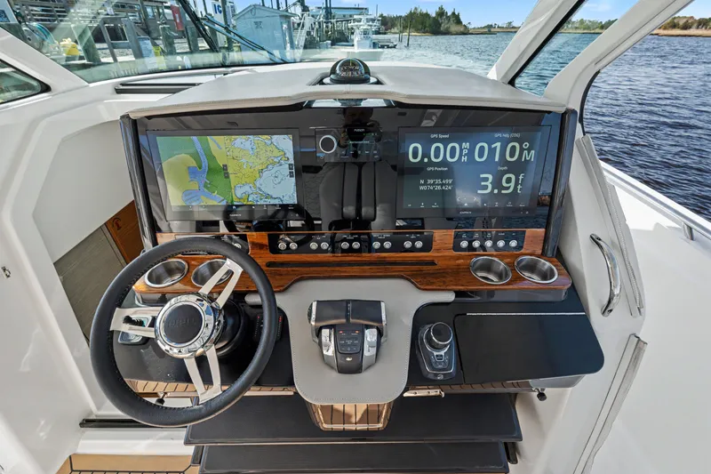 Slide: The Image of Cockpit of 2022 Tiara 38LS boat with advanced navigation displays and controls. - 12