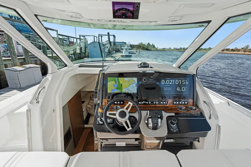 Slide: The Image of Cockpit view of 2022 Tiara 38LS boat with advanced navigation system. - 13