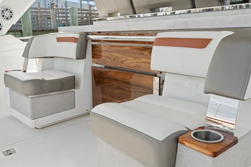 Slide: The Image of Luxury seating on 2022 Tiara 38LS yacht, featuring elegant wood accents and modern design. - 16
