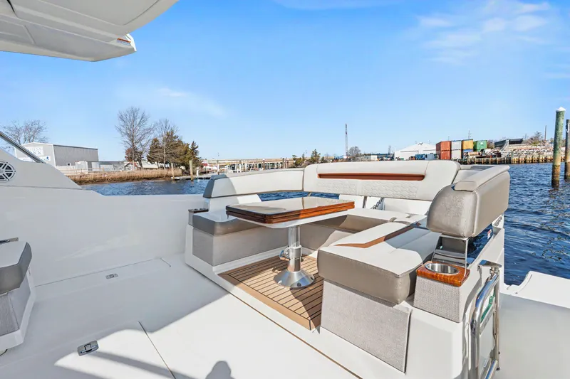 Slide: The Image of 2022 Tiara 38LS yacht with elegant seating and table on deck, dockside view. - 18