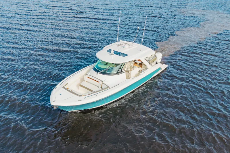 Slide: The Image of 2022 Tiara 38LS luxury boat cruising on open water. - 6