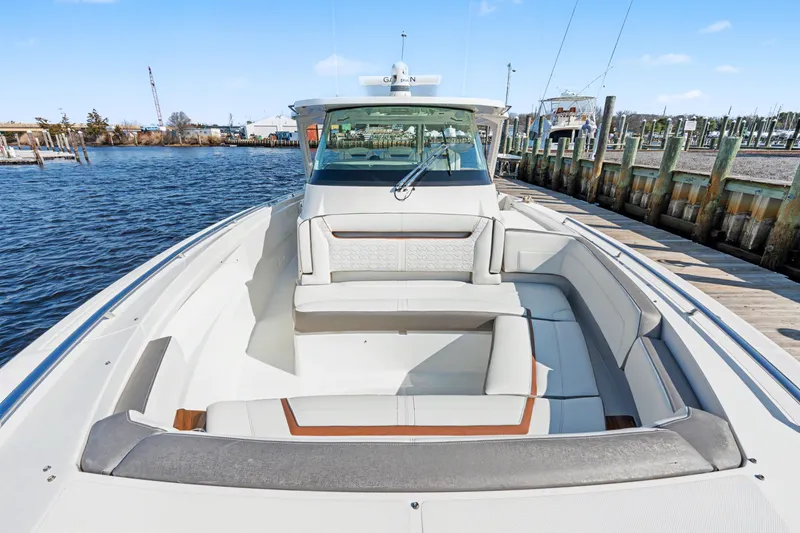 Slide: The Image of 2022 Tiara 38LS luxury boat docked, showcasing spacious seating and sleek design. - 9