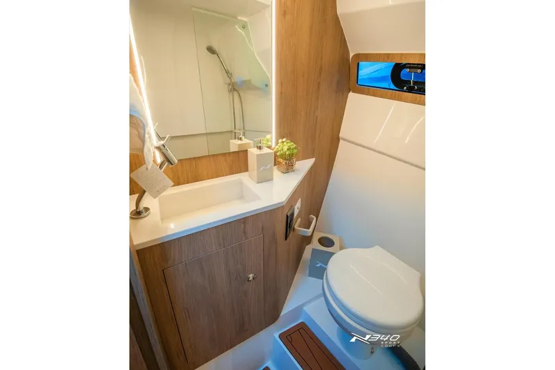 Slide: The Image of Modern bathroom interior of 2026 NX Boats NX340, featuring sleek design and compact amenities. - 13
