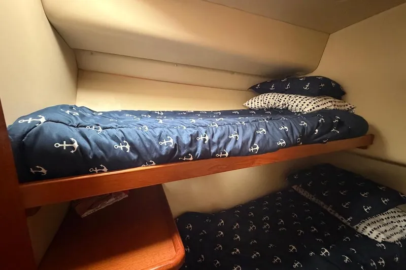 Slide: The Image of Bunk beds with nautical-themed bedding in a 2005 Riviera 37 Flybridge cabin. - 16