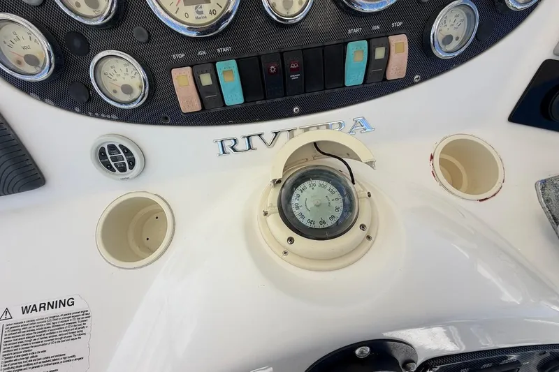 Slide: The Image of Control panel of a 2005 Riviera 37 Flybridge boat with gauges and compass. - 19