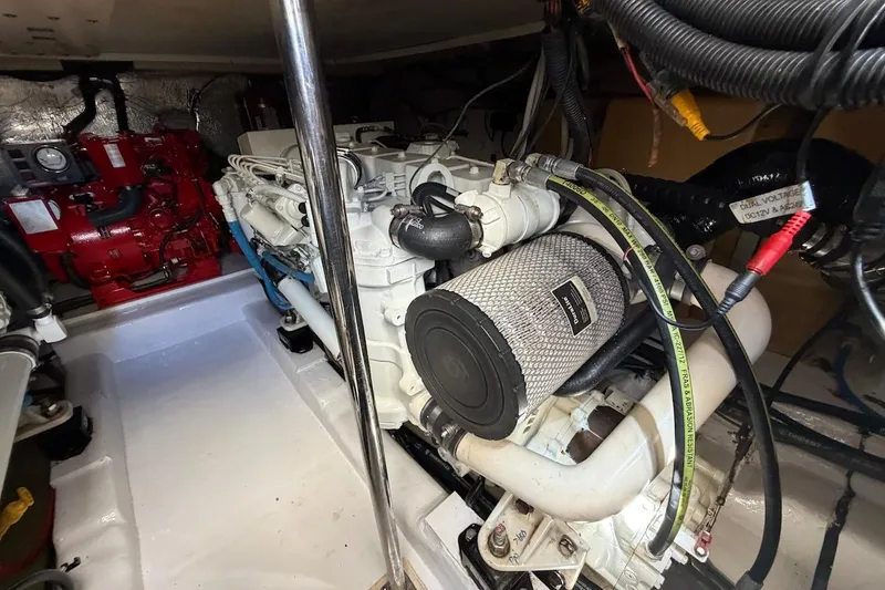 Slide: The Image of Engine room of 2005 Riviera 37 Flybridge yacht, showcasing detailed mechanical components. - 22