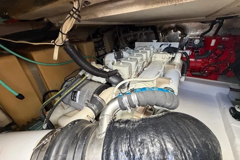 Slide: The Image of Engine compartment of 2005 Riviera 37 Flybridge boat, showcasing mechanical components. - 24